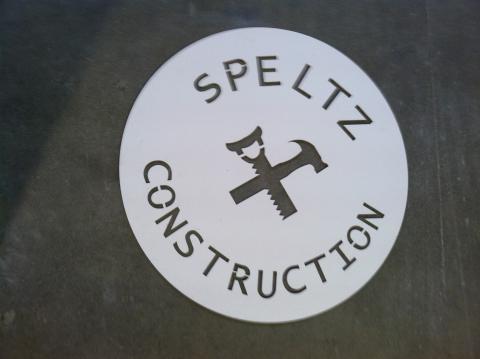Metal sign of Speltz Construction